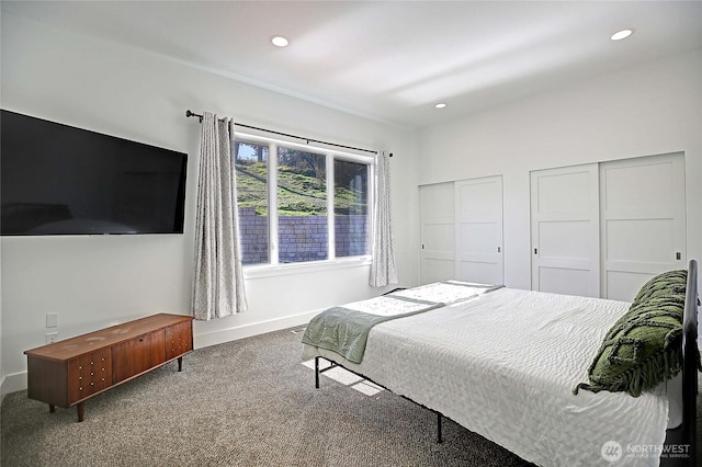 bedroom featuring recessed lighting, carpet flooring, baseboards, and multiple closets