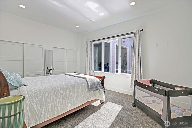 bedroom featuring recessed lighting, carpet, multiple closets, and baseboards