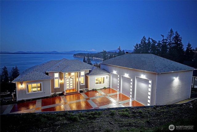 view of front of property with french doors, driveway, and an attached garage