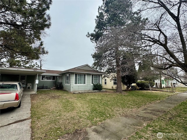 view of front of property with an attached carport and a front yard