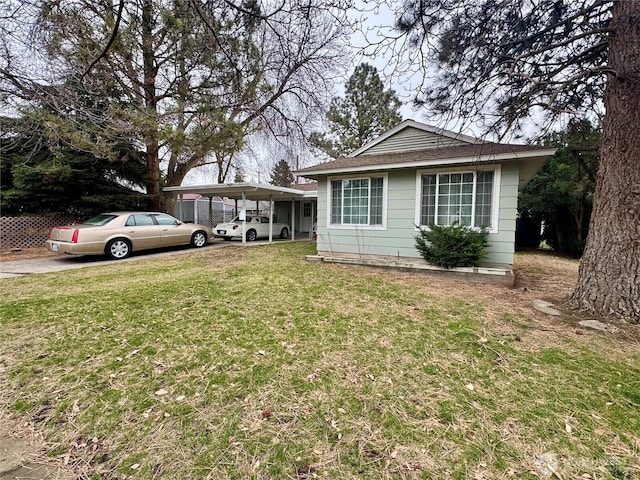 bungalow-style house featuring a carport, driveway, and a front lawn