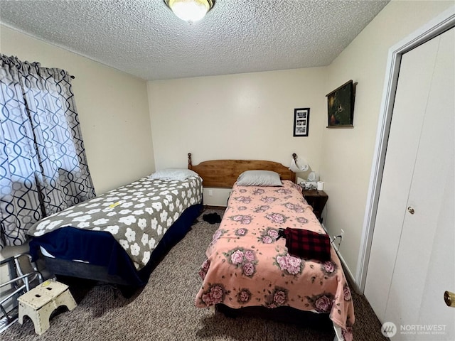 carpeted bedroom featuring a textured ceiling