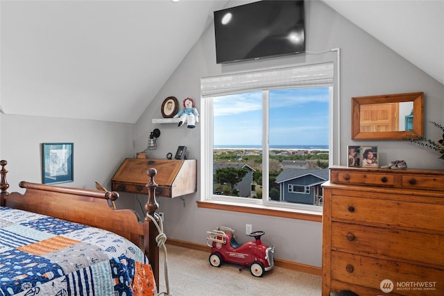 carpeted bedroom featuring baseboards and vaulted ceiling