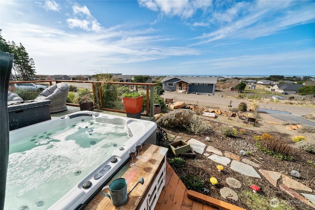 view of patio / terrace featuring a hot tub and a wooden deck