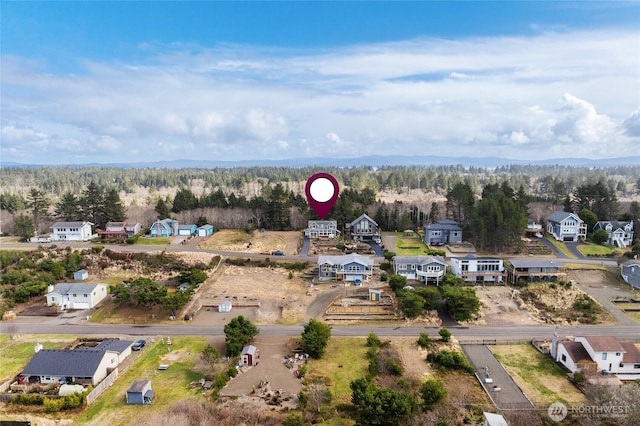 birds eye view of property with a view of trees