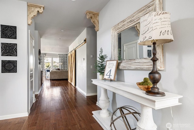 hallway with baseboards and hardwood / wood-style floors