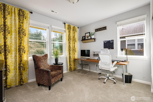 carpeted home office featuring baseboards and visible vents