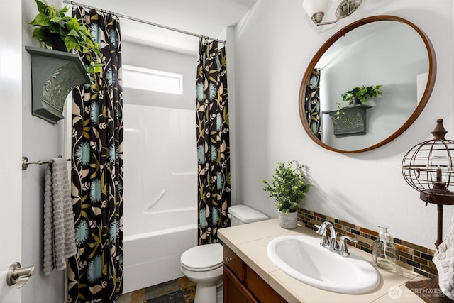 bathroom with toilet, shower / tub combo with curtain, stone finish flooring, tasteful backsplash, and vanity