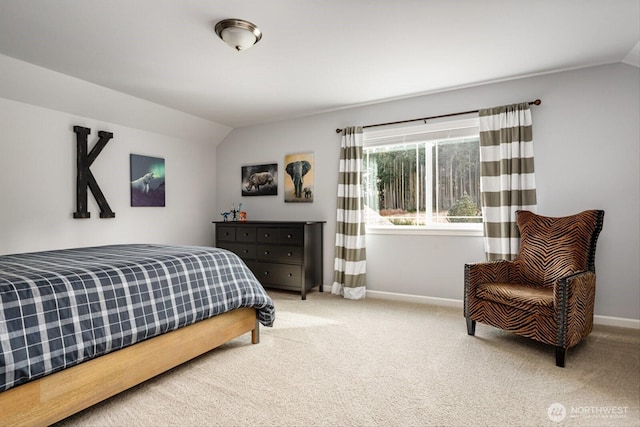 bedroom featuring baseboards, lofted ceiling, and carpet floors