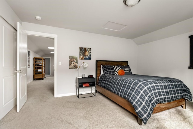 bedroom featuring attic access, carpet flooring, baseboards, and lofted ceiling