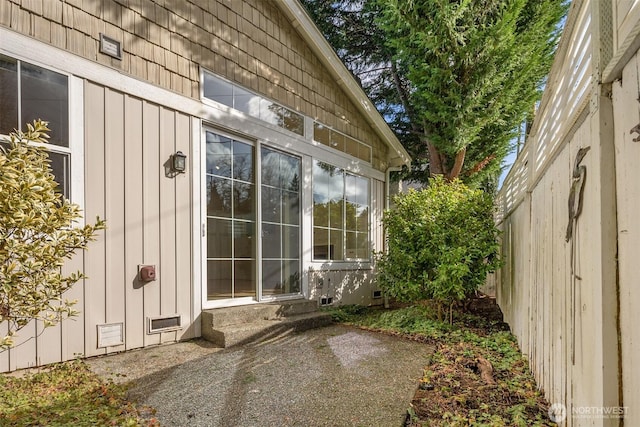 view of side of home featuring board and batten siding and a patio