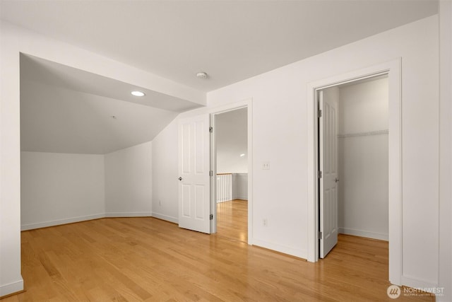 bonus room featuring lofted ceiling, recessed lighting, light wood-style flooring, and baseboards