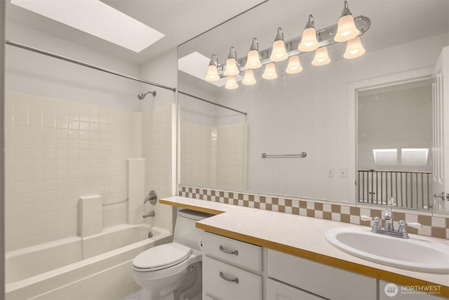 full bath featuring toilet, a skylight, washtub / shower combination, and vanity