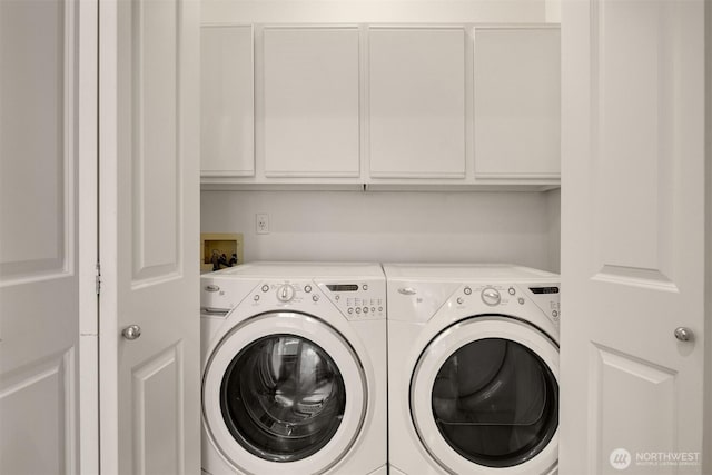 washroom with cabinet space and washer and dryer