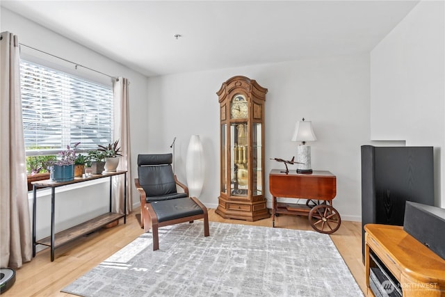 sitting room with light wood finished floors and baseboards