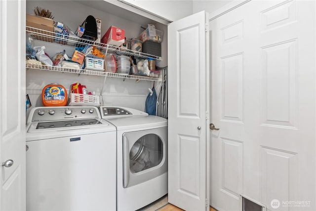 laundry room with laundry area, washing machine and dryer, and visible vents