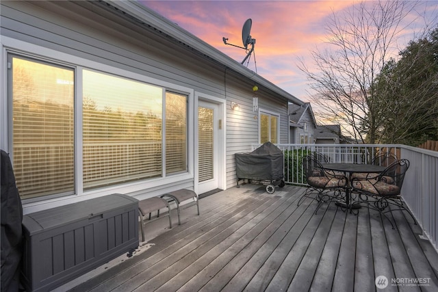 deck at dusk with grilling area