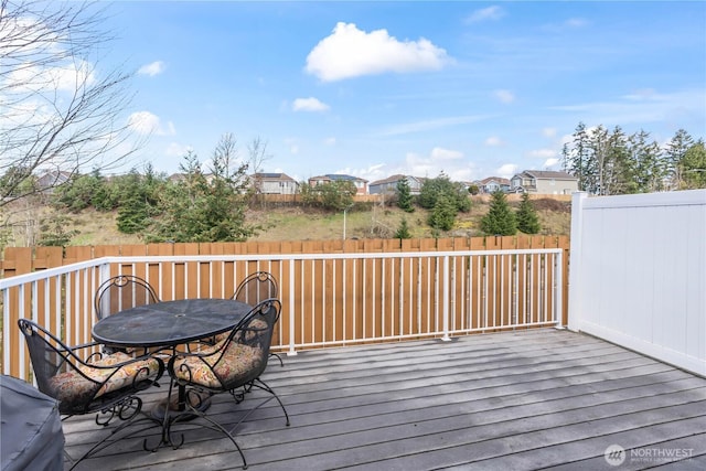 wooden deck with outdoor dining space and fence