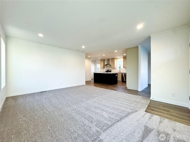 unfurnished living room with dark wood-style floors, recessed lighting, crown molding, and baseboards