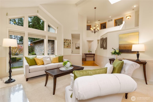 living area featuring recessed lighting, visible vents, a high ceiling, and a chandelier