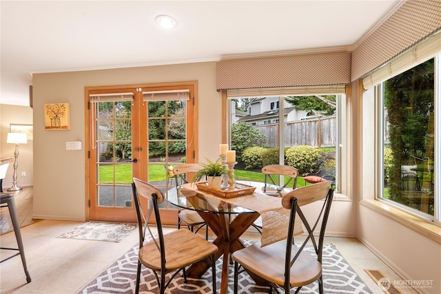 dining space with visible vents, french doors, baseboards, and ornamental molding