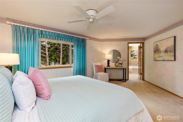 carpeted bedroom with ceiling fan, baseboards, and ensuite bath