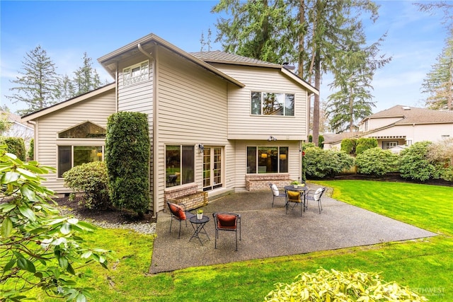 back of house with a patio and a yard