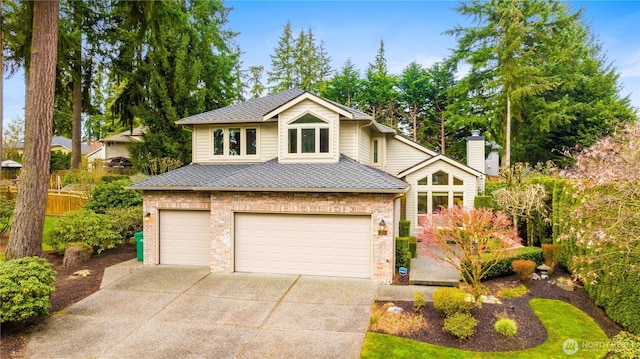 view of front of property featuring concrete driveway, an attached garage, brick siding, and a shingled roof