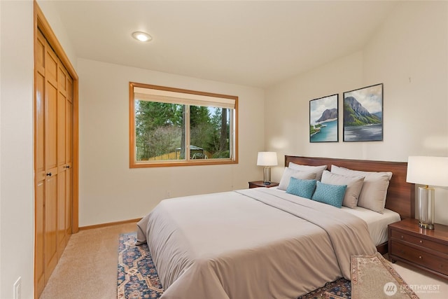 bedroom with carpet flooring, baseboards, and a closet