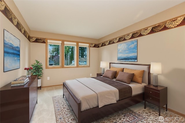 bedroom featuring baseboards and light carpet