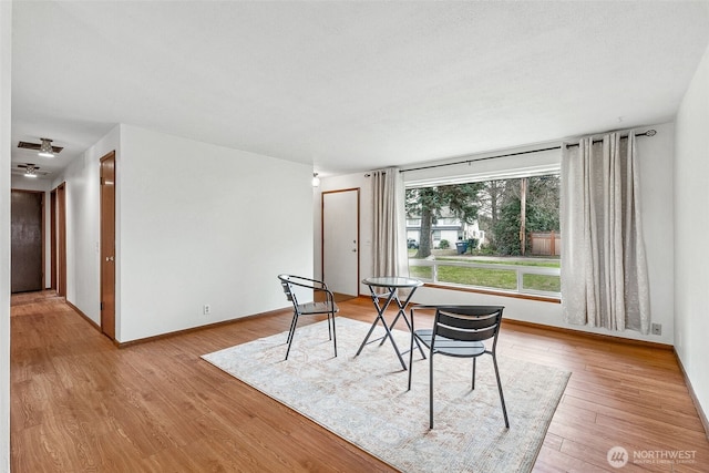 dining space featuring wood finished floors and baseboards