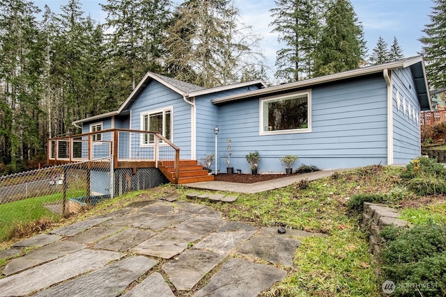 view of front of home with fence and a wooden deck