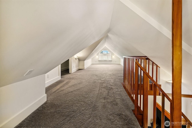 additional living space with vaulted ceiling, carpet flooring, visible vents, and baseboards