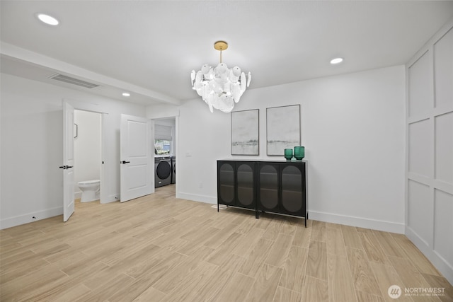 interior space with a notable chandelier, recessed lighting, washer / clothes dryer, visible vents, and light wood-style flooring