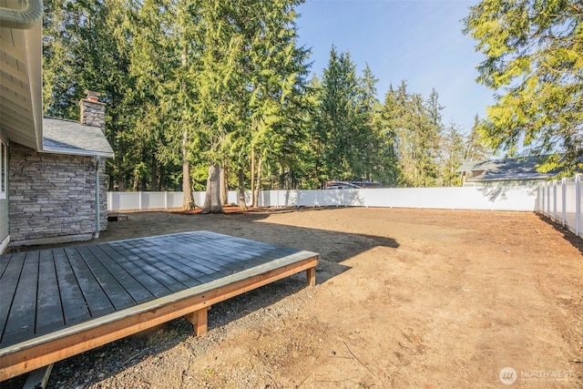 view of yard with a fenced backyard and a deck