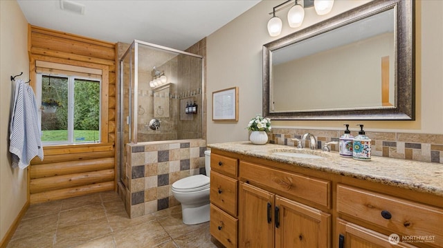 bathroom with visible vents, toilet, tiled shower, and vanity