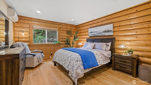 bedroom featuring recessed lighting, an AC wall unit, and light wood-type flooring