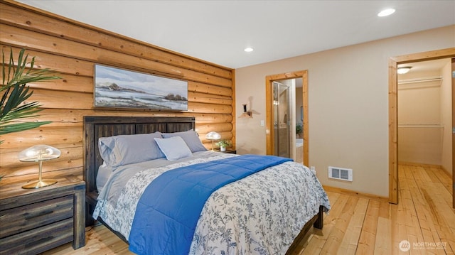 bedroom with recessed lighting, visible vents, wood-type flooring, and rustic walls