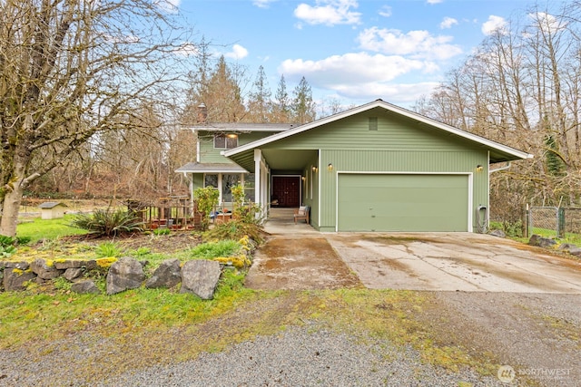 view of front of house with driveway, covered porch, and an attached garage