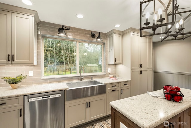 kitchen with tasteful backsplash, a wainscoted wall, recessed lighting, stainless steel dishwasher, and a sink