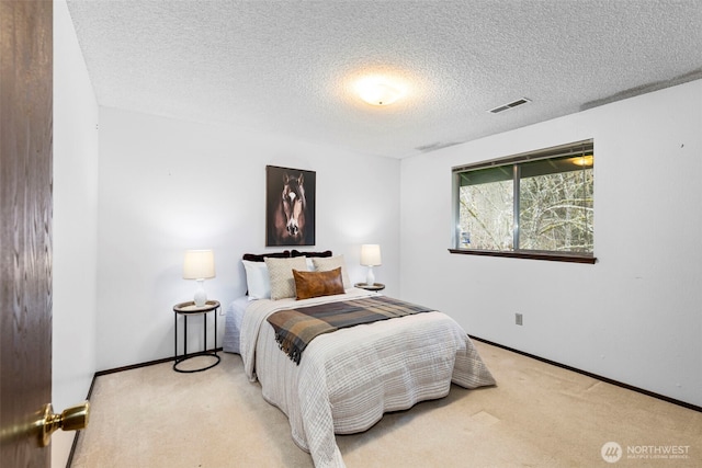 bedroom with visible vents, baseboards, carpet, and a textured ceiling