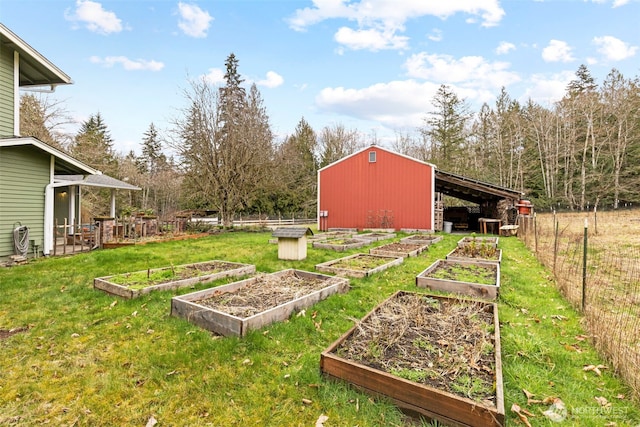 view of yard with an outbuilding, a vegetable garden, fence, and an outdoor structure