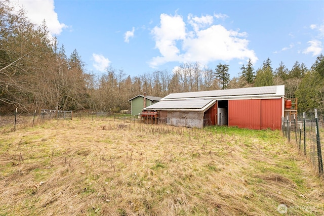 view of yard with an outbuilding and fence