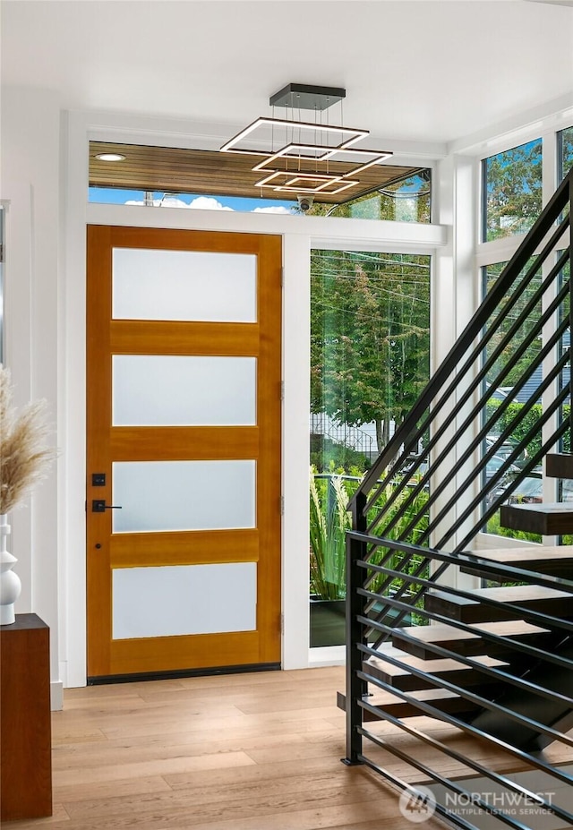 entryway with stairs and light wood-style flooring