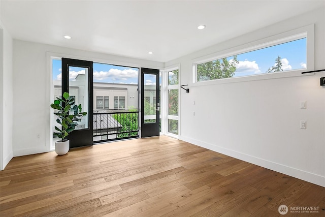 interior space featuring recessed lighting, wood finished floors, and baseboards