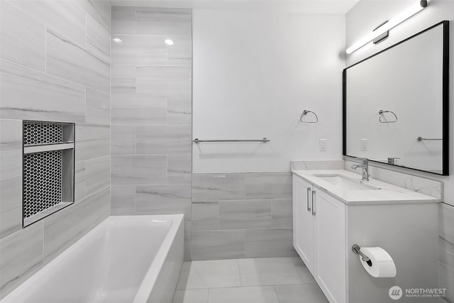 full bath with a bath, tile patterned floors, tile walls, and vanity