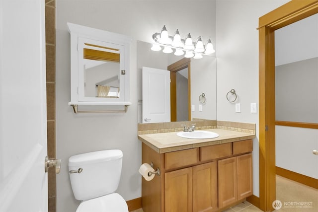 bathroom with toilet and vanity