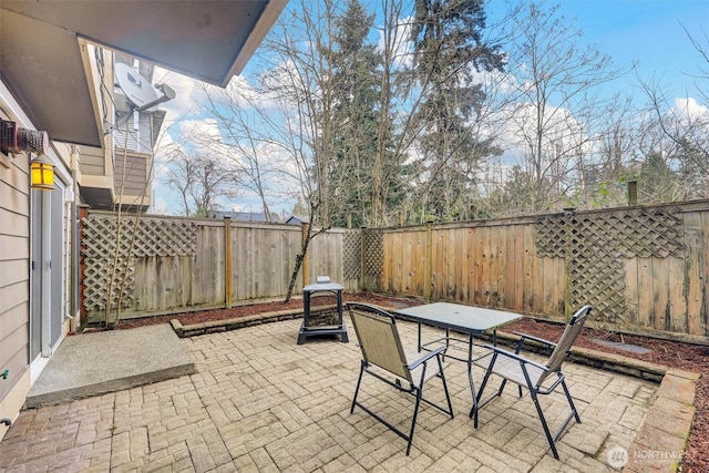 view of patio featuring a fenced backyard and outdoor dining area