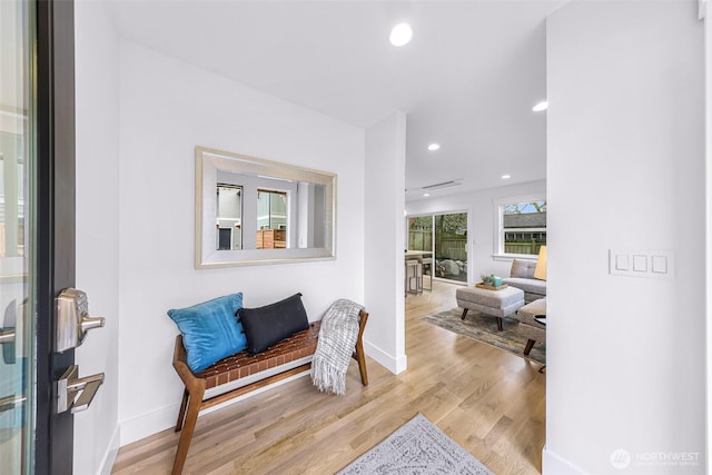 interior space featuring recessed lighting, baseboards, and wood finished floors