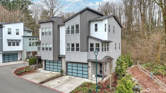 view of front of home with an attached garage, board and batten siding, and concrete driveway